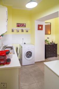 a kitchen with a washing machine and a sink at Via Del Centro in Sibiu