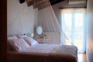 A bed or beds in a room at The Red Bougainvillea Apartments