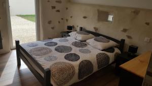 a bed with two pillows on it in a bedroom at Gite de la Haie in Apremont