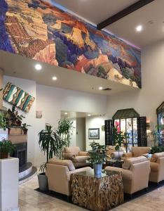 a lobby with a large painting on the wall at Grand Canyon Plaza Hotel in Tusayan