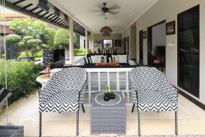 twee stoelen en een tafel op een patio bij Villa Bloom 1 - 4 bedrooms, 4 bathrooms, private pool close to the beach in Seminyak