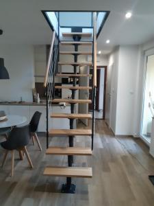 a spiral staircase in a kitchen with a table and chairs at Apartamenty Platinum in Łukęcin