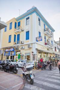 a building with motorcycles parked in front of it at Amalia City Rooms in Chios