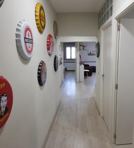 a hallway with many plates on the wall at Apartamento Barajas. Aeropuerto/Ifema in Madrid