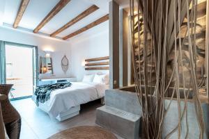 A bed or beds in a room at Bohemian Luxury Boutique Hotel, Adults Only