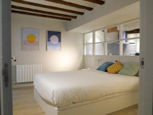 una camera da letto con un grande letto bianco e finestre di El Oasis de la Estafeta a Pamplona