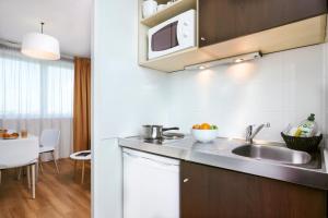 A kitchen or kitchenette at Aparthotel Adagio Access Strasbourg Illkirch