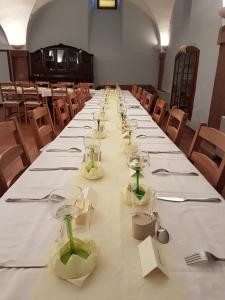 a long table with glasses and napkins on it at Ancien Presbytère Albert Schweitzer in Gunsbach