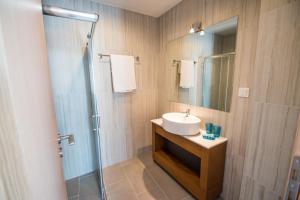 a bathroom with a sink and a shower at Mare Civitas Apartments in Chania Town