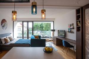 a living room with a bed and a dining room at Cosy Design Apartment IV in Brno