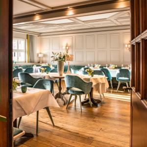 a restaurant with tables and chairs in a room at Hotel & Restaurant Sonne in Kirchzarten