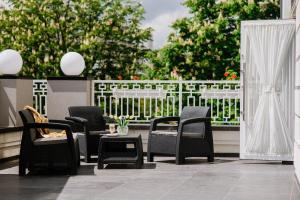 a group of chairs and a table on a patio at Hotel Alkor in Truskavets