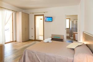 A bed or beds in a room at MOLAROTTO CAMERE CON ANGOLO COTTURA