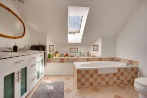 a bathroom with a large tub and a sink at Our Space the Perfect Place B&B in Picton