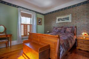 a bedroom with a bed and a dresser and a window at Our Space the Perfect Place B&B in Picton