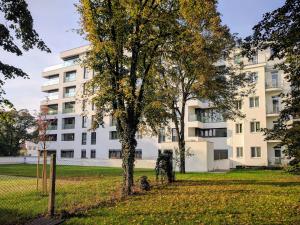 an apartment building with trees in a park at Cosy Design Apartment IV in Brno