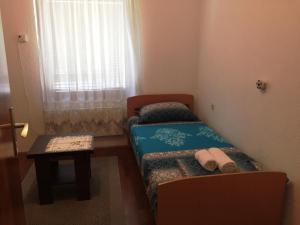 Cama ou camas em um quarto em Niš Apartman