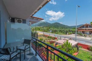 a balcony with chairs and a view of a road at Katerina Rooms & Apartments in Skala Potamias