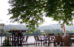 a group of tables and chairs with a view of the water at Hotel Zur Kripp in Koblenz