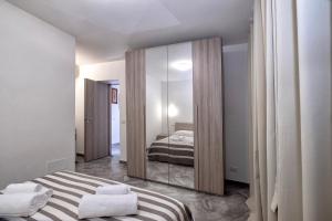 a bedroom with a mirror and a bed in it at Casa delle rose in Verbania