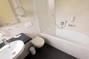 a bathroom with a sink and a toilet and a shower at Hotel Katharina Garni in Tübingen