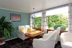 a dining room with a table and white chairs at Hotel Katharina Garni in Tübingen