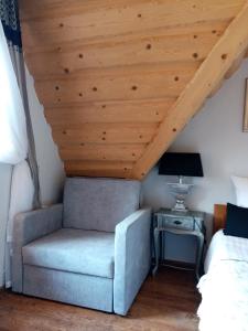 una sedia in una camera da letto con soffitto in legno di U Hanki a Biały Dunajec