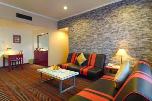 a living room with a couch and a table at Hotel Shangri-la Kota Kinabalu in Kota Kinabalu