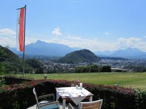 a table and chairs with a view of a city at Hotel Schöne Aussicht in Salzburg