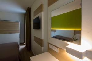 A bed or beds in a room at Almalux Jesolo Wellness & Spa 3 stelle superior