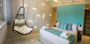 a bedroom with a swinging bed and a hammock at Kotroni Villas in Finikounta