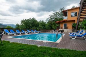 - une piscine avec des chaises et un bouquet d'équipements dans l'établissement Casa Encosta do Gerês-Ferias no Gerês, à Vieira do Minho