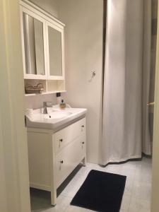 a white bathroom with a sink and a shower at Casa Pallamaio Historic Center Vicenza in Vicenza