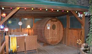 a large wooden barrel on a deck with christmas lights at Sitzmark Chalet Inn in Ruidoso