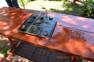 a picnic table with a stove with cookies on it at Sitzmark Chalet Inn in Ruidoso