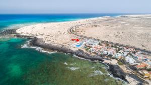 an aerial view of a resort on a beach at Hotel Boutique TAO Caleta Mar in Corralejo