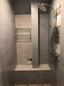 a bathroom with a shower with two pairs of shoes at MKA Life in Ventspils