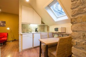 a kitchen with a table and chairs and a window at City Flats by Lybeer Hotel Group in Bruges