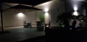 a dark room with a patio with an umbrella and chairs at Il fiore di loto in San Felice Circeo