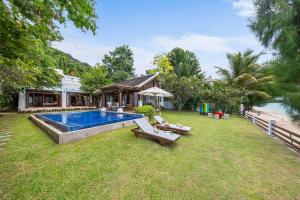 uma imagem de um quintal com uma piscina em The Emerald Hill Beach Villa em Mae Nam