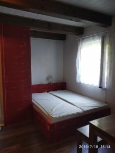 a bed in a room with a window at Apartments Cederika in Věžovatá Pláně