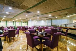 a dining room with purple chairs and tables at Congress Plaza Hotel Chicago in Chicago