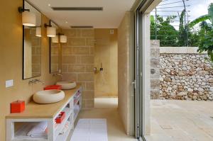 a bathroom with two sinks and a walk in shower at Masseria Trapana in Lecce