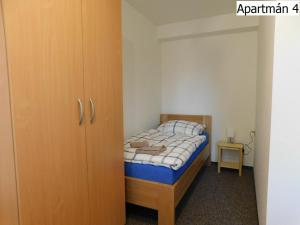 A bed or beds in a room at Apartmány Horní Planá