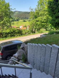 een auto geparkeerd naast een stenen hek bij Ferienwohnung Viktoria in Lenzkirch