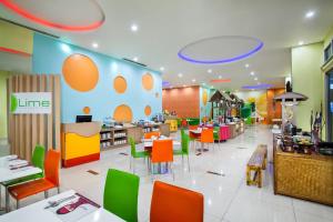 un restaurant avec des chaises et des tables colorées dans une cafétéria dans l'établissement favehotel Manahan - Solo, à Solo