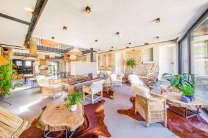 a living room with tables and chairs at Domaine de Ronchinne - Maison du Jardinier in Maillen