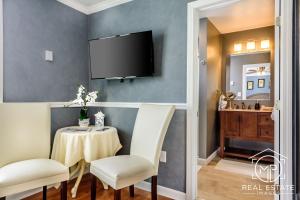 a dining room with a table and a tv on the wall at Bouchard Restaurant & Inn in Newport