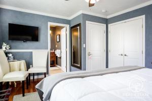 a bedroom with blue walls and a bed and a table at Bouchard Restaurant & Inn in Newport