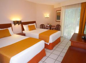 Giường trong phòng chung tại Hotel Viva Villahermosa